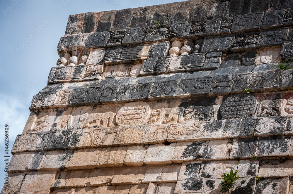 Detail of the carvings on a stone wall at the Temple of the Jaguars in Chichen Itza, Yucatan Peninsula, Mexico.