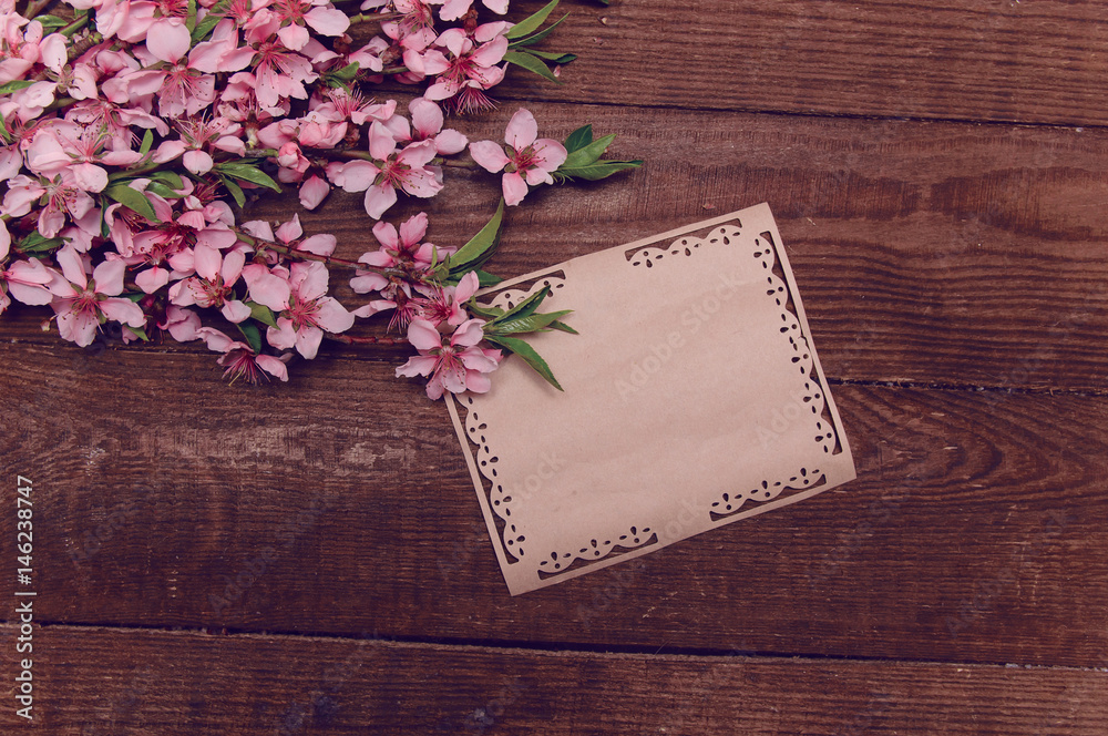 Note, postcard, writing retro peach blossoms on a wooden vintage tablee