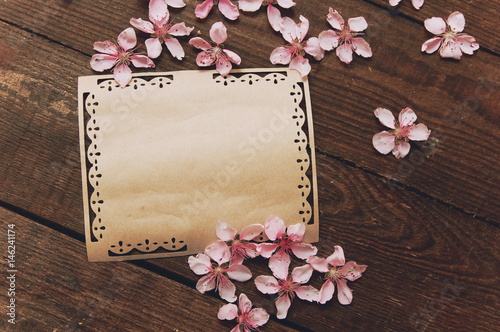 Note  postcard  writing of peach tree flowers on a wooden vintage table