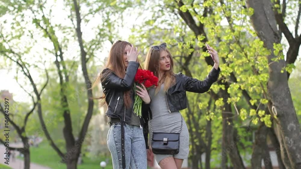 two beautiful girls are doing selfie on phone closeup two beautiful girls are doing selfie on phone closeup