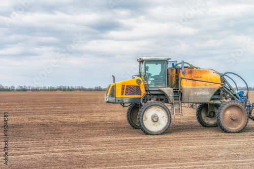  Tractor preparing the field before seeding the ground. Wheat - main crops  which are grown in Ukraine