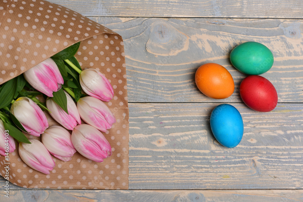 colorful easter eggs in nest, pink beautiful tulips, mothers day