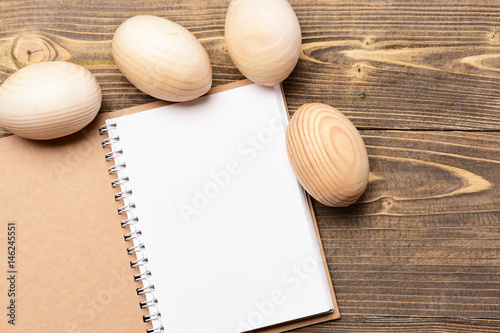 paper notebook and wooden easter eggs, cooking and menu design