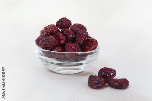 Horizontal shot of a bowl of cranberries on a white background photo