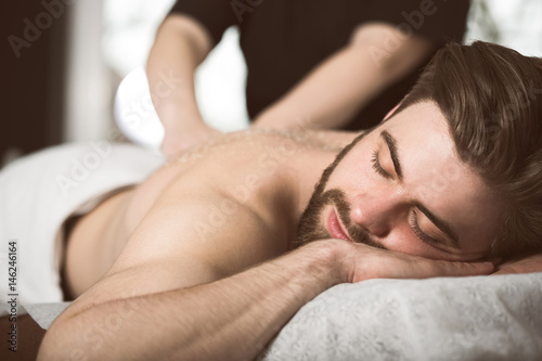 Man relaxing during a salt scrub beauty therapy