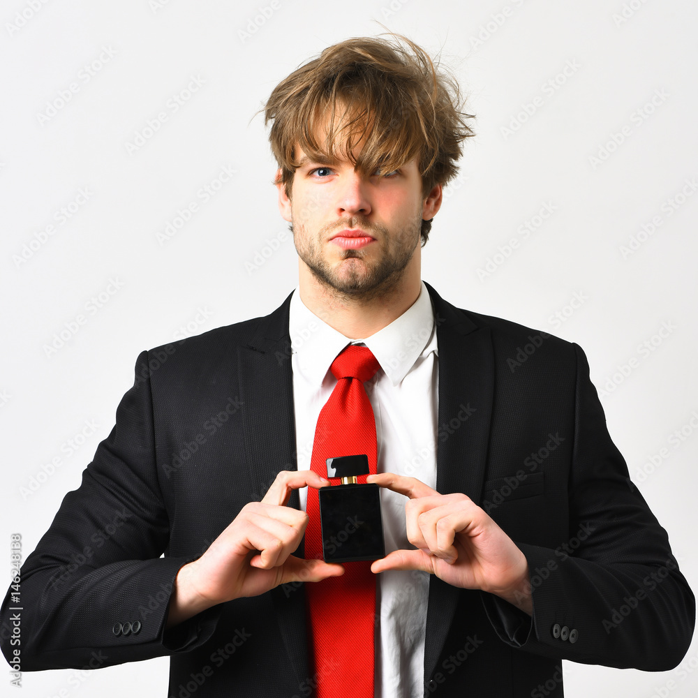 Caucasian stylish man posing with perfume isolated on white Caucasian stylish man posing with perfume isolated on white