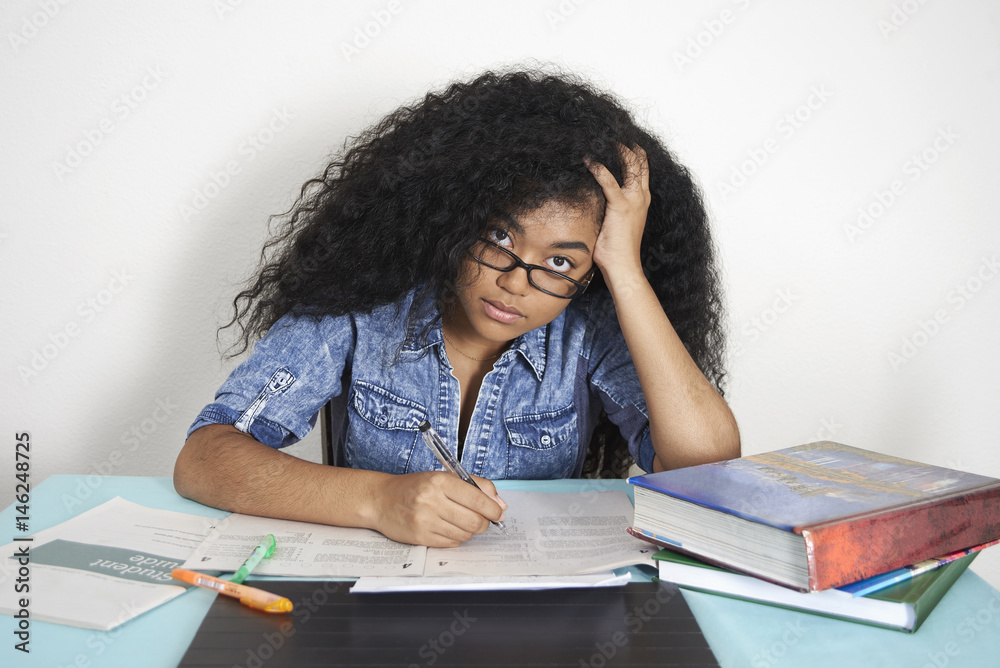 Frustrated Mixed Race teenage girl doing homework Frustrated Mixed Race teenage girl doing homework