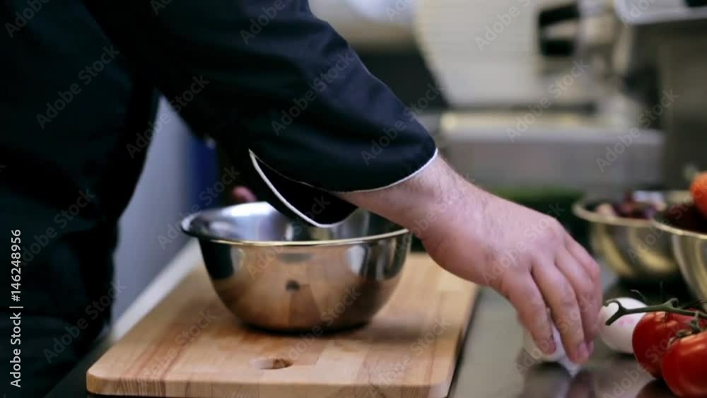 hands of male chef cook breaking eggs in kitchen hands of male chef cook breaking eggs in kitchen