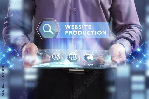 Business, Technology, Internet and network concept. Young businessman working on a virtual screen of the future and sees the inscription: Website production