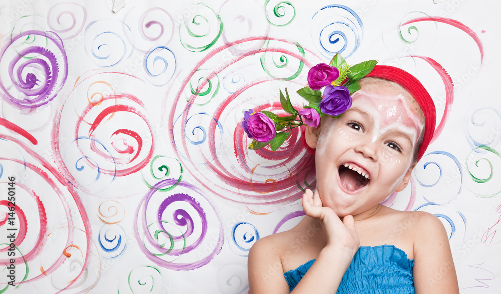 Fototapeta premium Portrait of a child with flowers