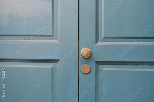 Classic blue door with brass handle and lock