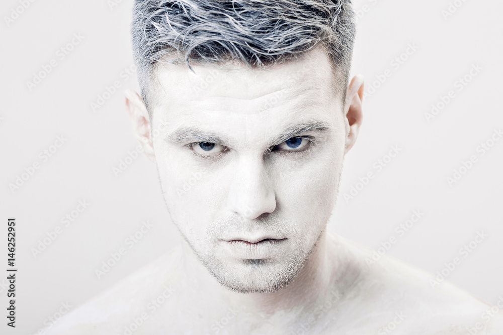 portrait of young man with white face paint. Professional Fashion