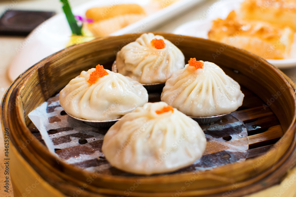 Steamed pork baozi in soup on a steamer Steamed pork baozi in soup on a steamer
