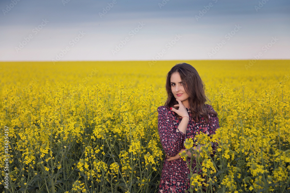Spring portrait of a woman in the rapeseed field Spring portrait of a woman in the rapeseed field