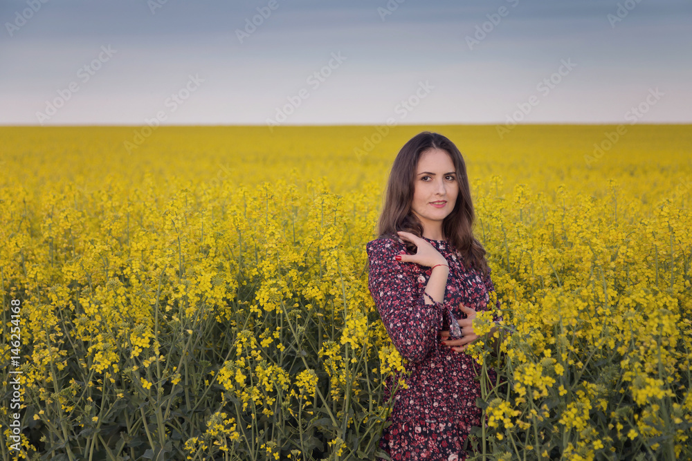Spring portrait of a woman in the rapeseed field Spring portrait of a woman in the rapeseed field