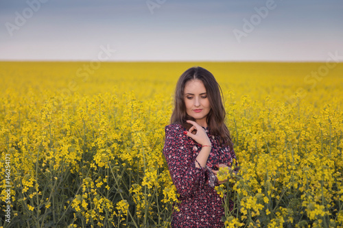 Spring portrait of a woman in the rapeseed field © alexionutcoman