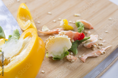 Cut vegetables on a wooden board. Red and yellow peppers, Broccoli. photo