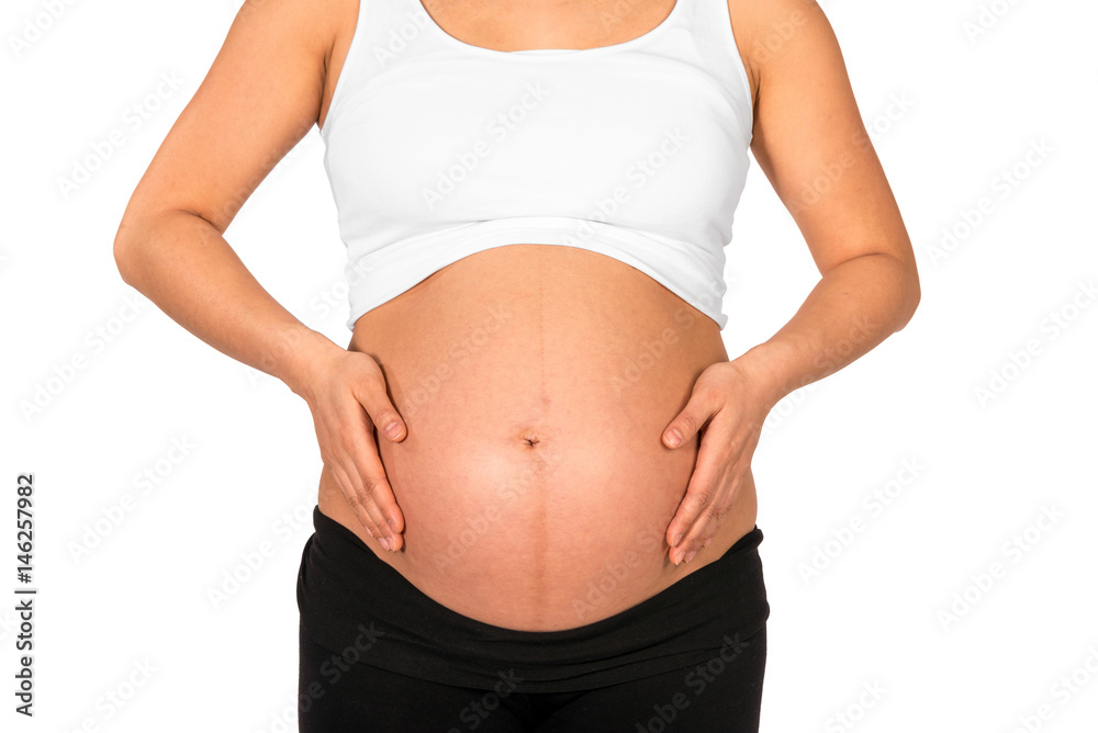 Pregnant woman embracing her bare belly with white background Pregnant woman embracing her bare belly with white background