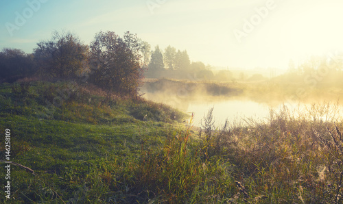 Foggy autumn landscape with river