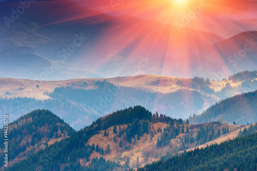 Wonderful landscape  of mountains in spring. View of the hills covered with forest in the rays of sunlight.