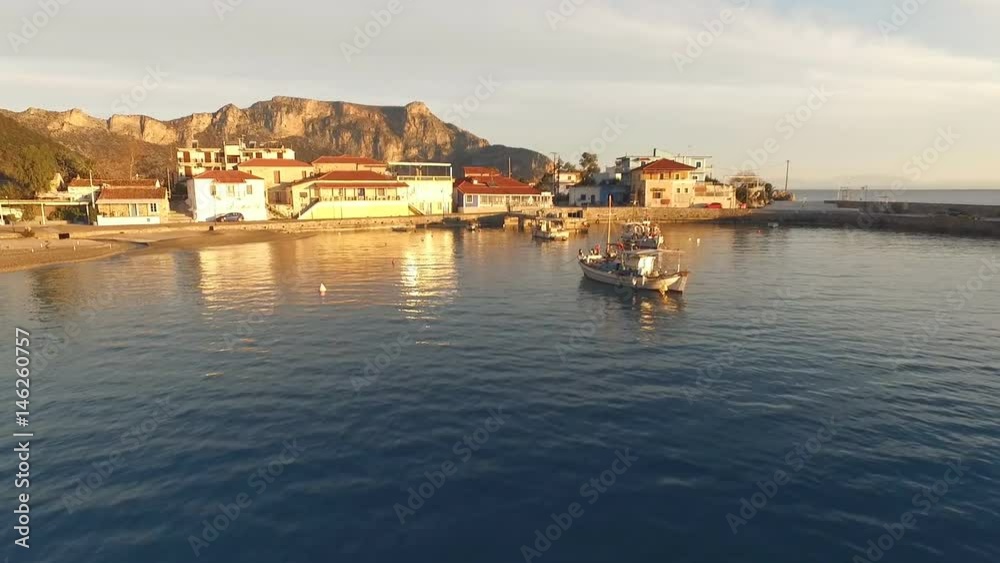 The little fishing boats stand on a dock near the old Greek town. The little fishing boats stand on a dock near the old Greek town.