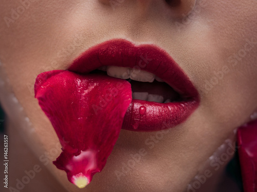 Closeup on attractive sensual woman relaxing in spa bath with flower rose petals background