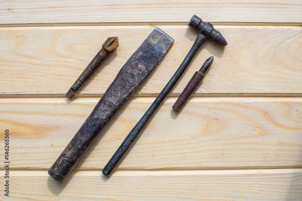 Old rusty hammer and drill on wood background. Old rusty industrial home tools Old rusty hammer and drill on wood background. Old rusty industrial home tools