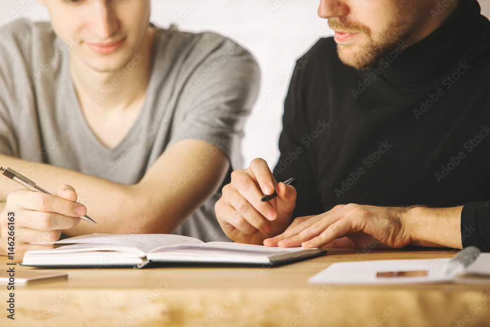 Focused boys doing paperwork Focused boys doing paperwork