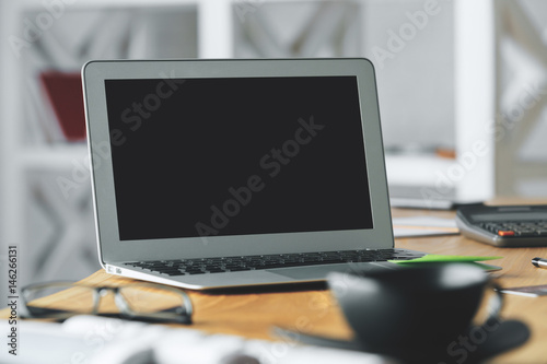 Workplace with blank laptop