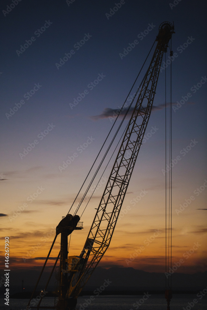 Arm of a crane at sunset.