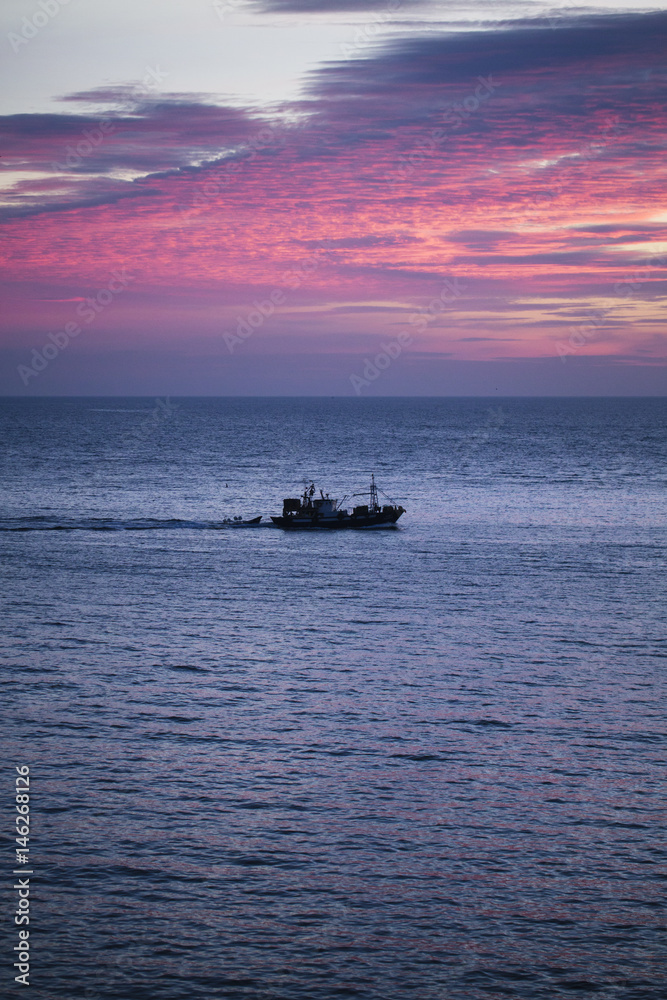 Boat at sunset of the sea