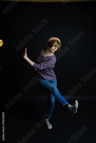 young pretty woman dancing, happy girl dancing on dark background