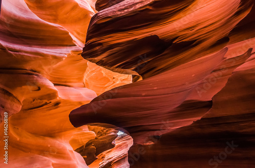 Dark orange wave shapes photographed at slots canyons sunset in Arizona.