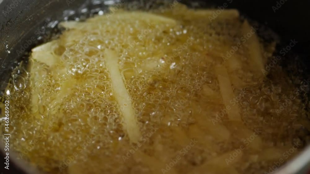 French fries on a frying pan. Slowmo French fries on a frying pan. Slowmo
