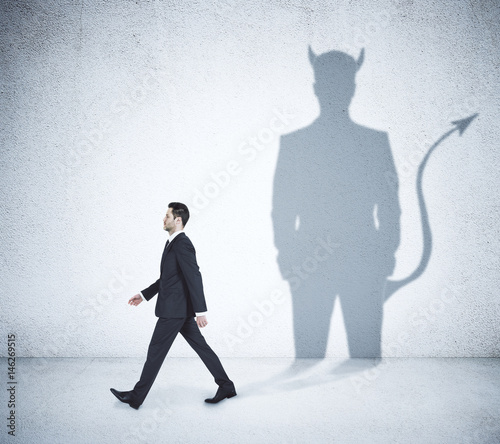 Quadro su tela Walking businessman with devil shadow