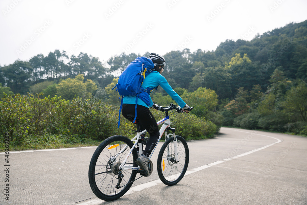 cyclist cycling mountain bike on foggy forest trail