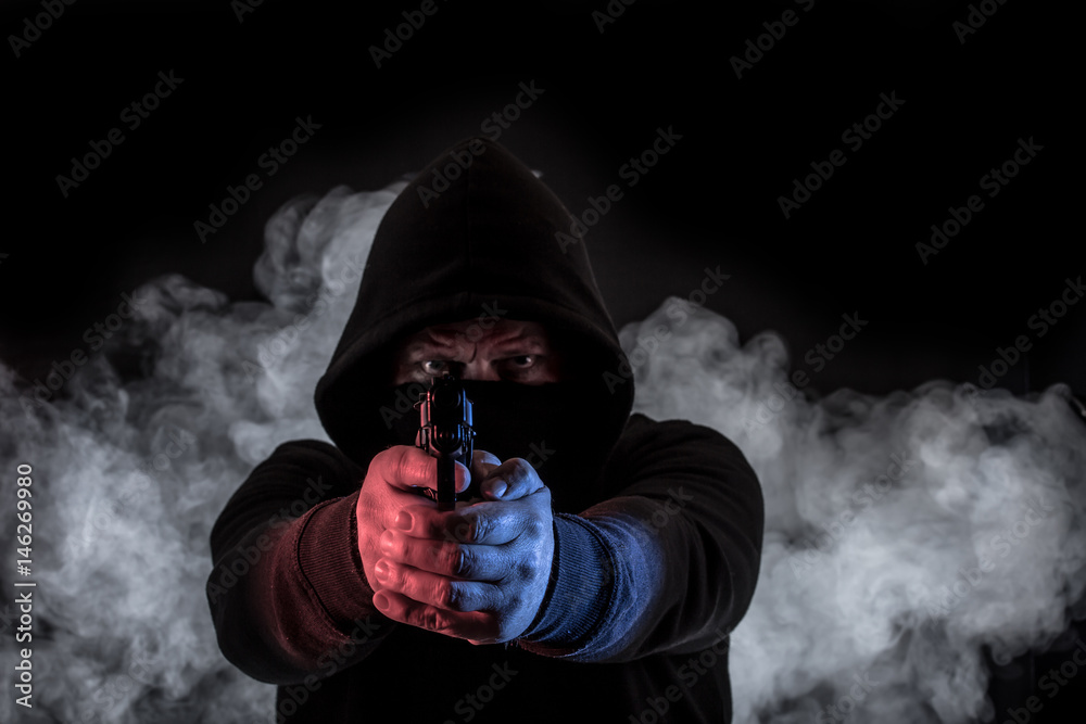 A gangster makes a raid with a gun
A gangster makes a raid with a gun