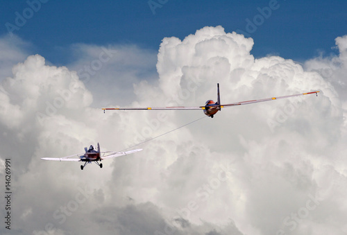 Tow plane pulls a glider into the sky photo