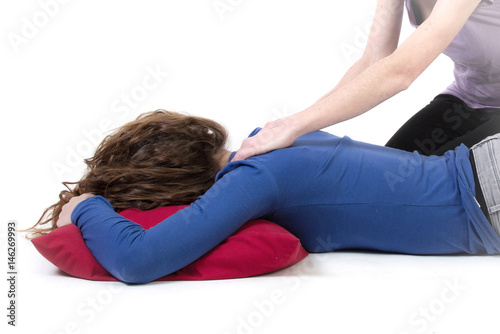 Woman getting back massage in a white room