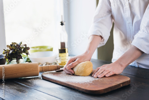 Step by step the chef prepares ravioli with ricotta cheese, yolks quail eggs and spinach with spices. The chef works with the dough