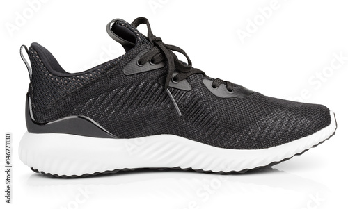 Single new unbranded black sport running shoe, sneakers or trainers isolated on white background with clipping path