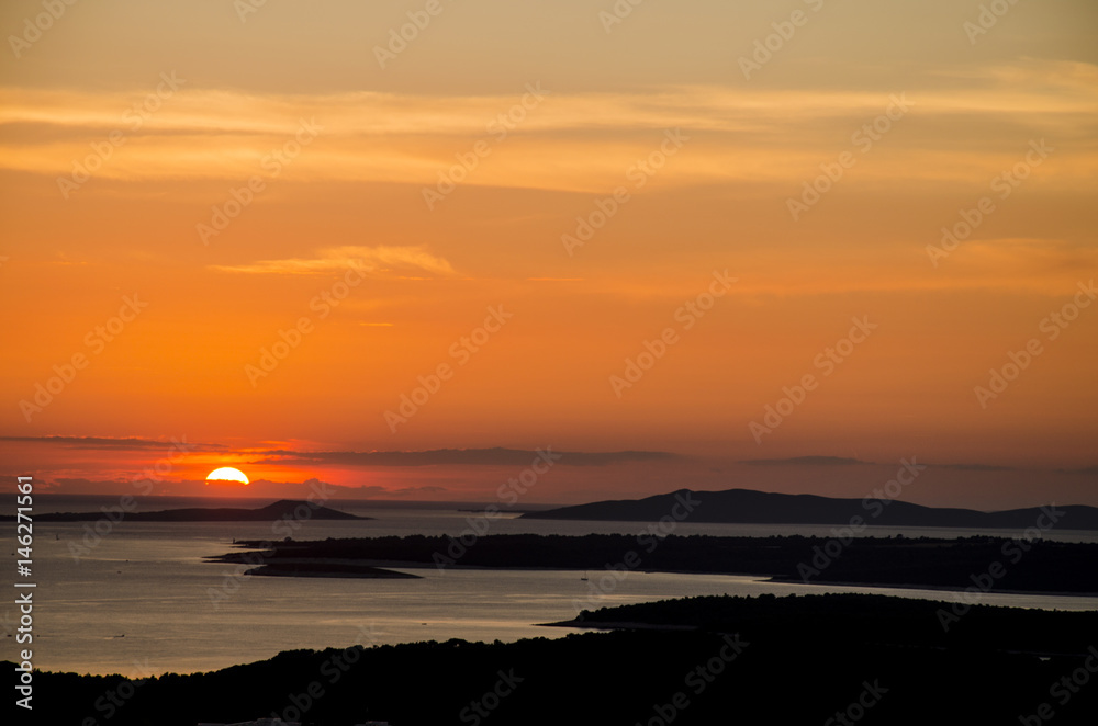 the sky is on fire, scenic seascape of the sunset over the sea, whit black silhouette of islands