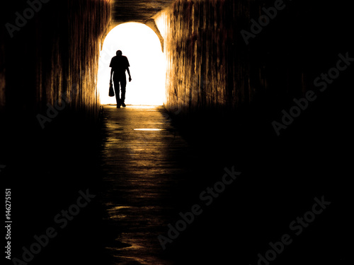Old Man Walking Through Tunnel