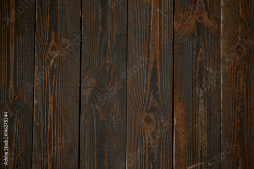 Dark brown textured wooden plates. Vertical background.