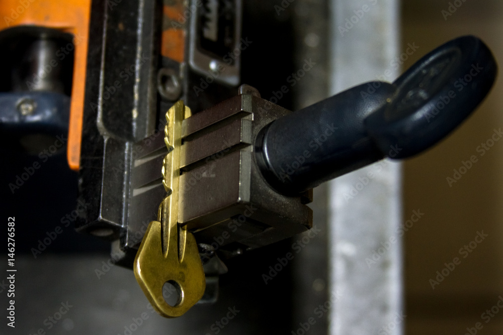 Machine production of duplicate metal key. Machine production of duplicate metal key.