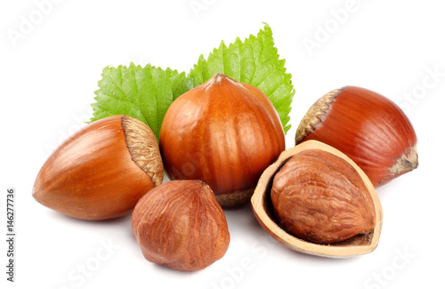 hazelnuts with green leaf isolated on white background