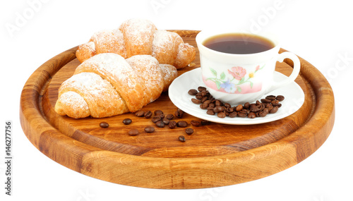 fresh croissant with coffee on wood background