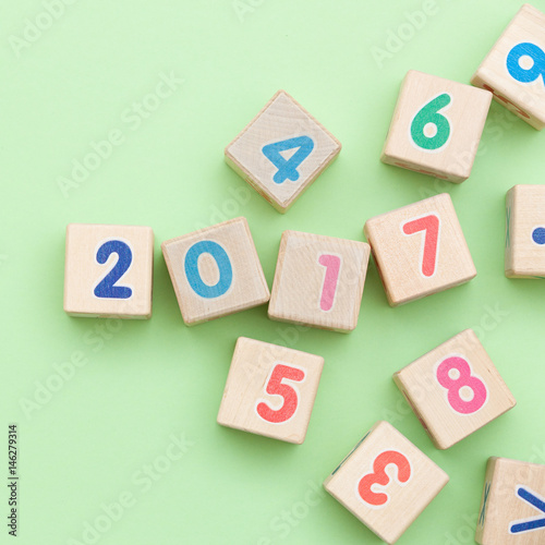 Wooden cubes with numbers on light green background