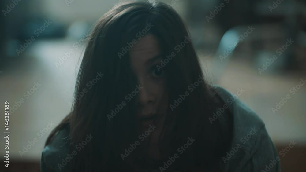 Young attractive caucasian brunette girl get surprised and falls backward in living room, close up slow motion Young attractive caucasian brunette girl get surprised and falls backward in living room, close up slow motion