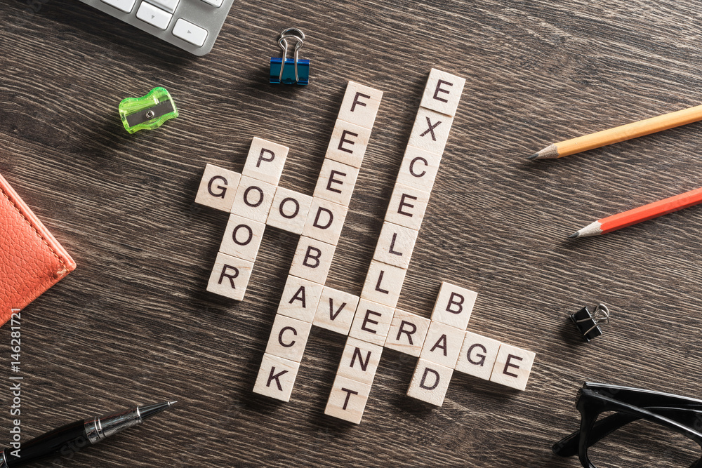 Conceptual media keywords on table with elements of game making crossword Conceptual media keywords on table with elements of game making crossword